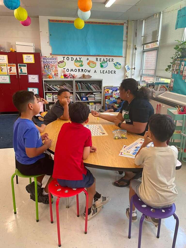 Students working with thier teacher 