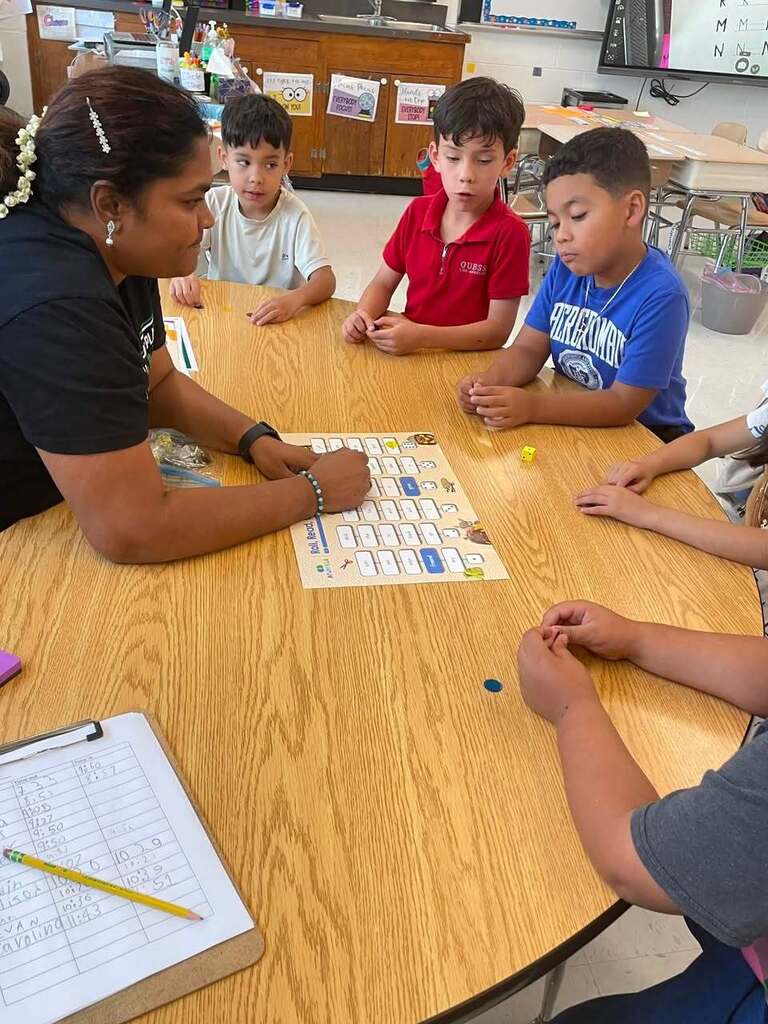students working with their teacher