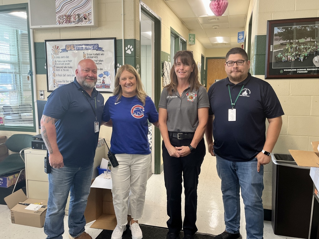 Four adults pose for a photo before conducting a fire drill