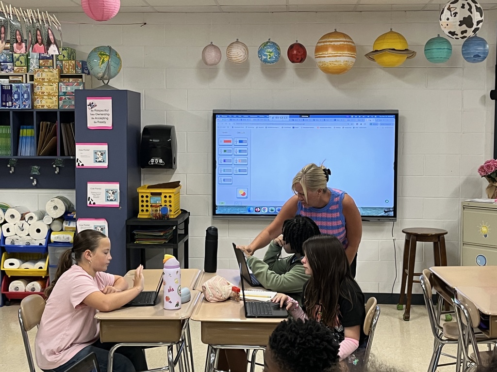 Converting improper fractions to mixed numbers during Math in Ms. McCowen's class! 