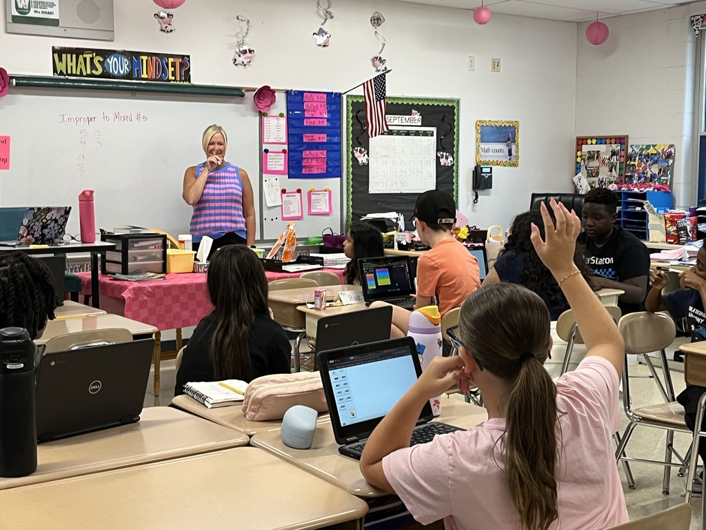 Converting improper fractions to mixed numbers during Math in Ms. McCowen's class! 