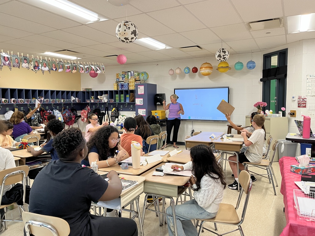 Converting improper fractions to mixed numbers during Math in Ms. McCowen's class! 