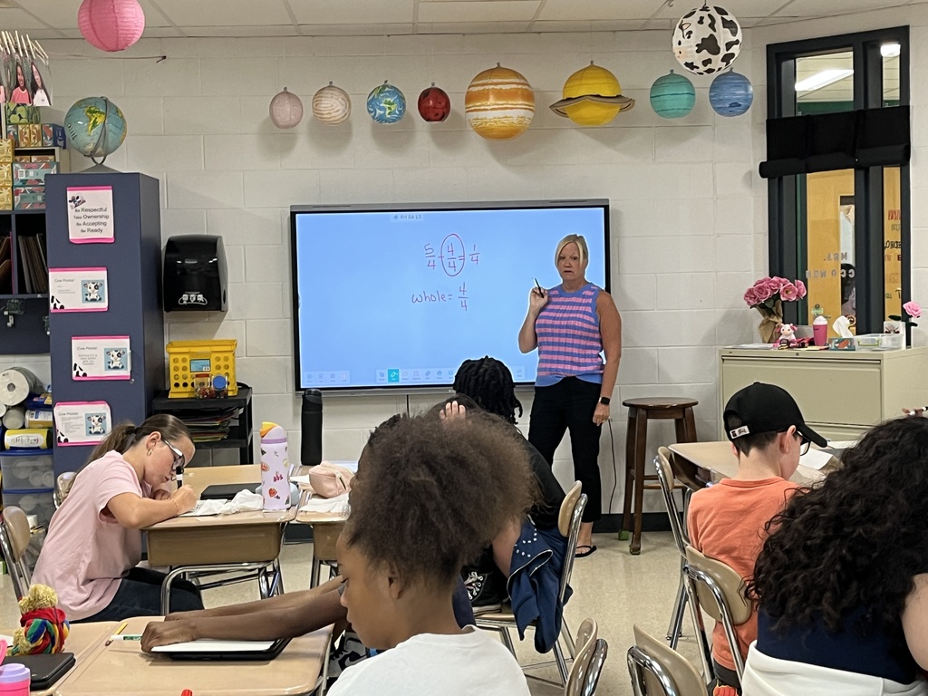 Converting improper fractions to mixed numbers during Math in Ms. McCowen's class! 