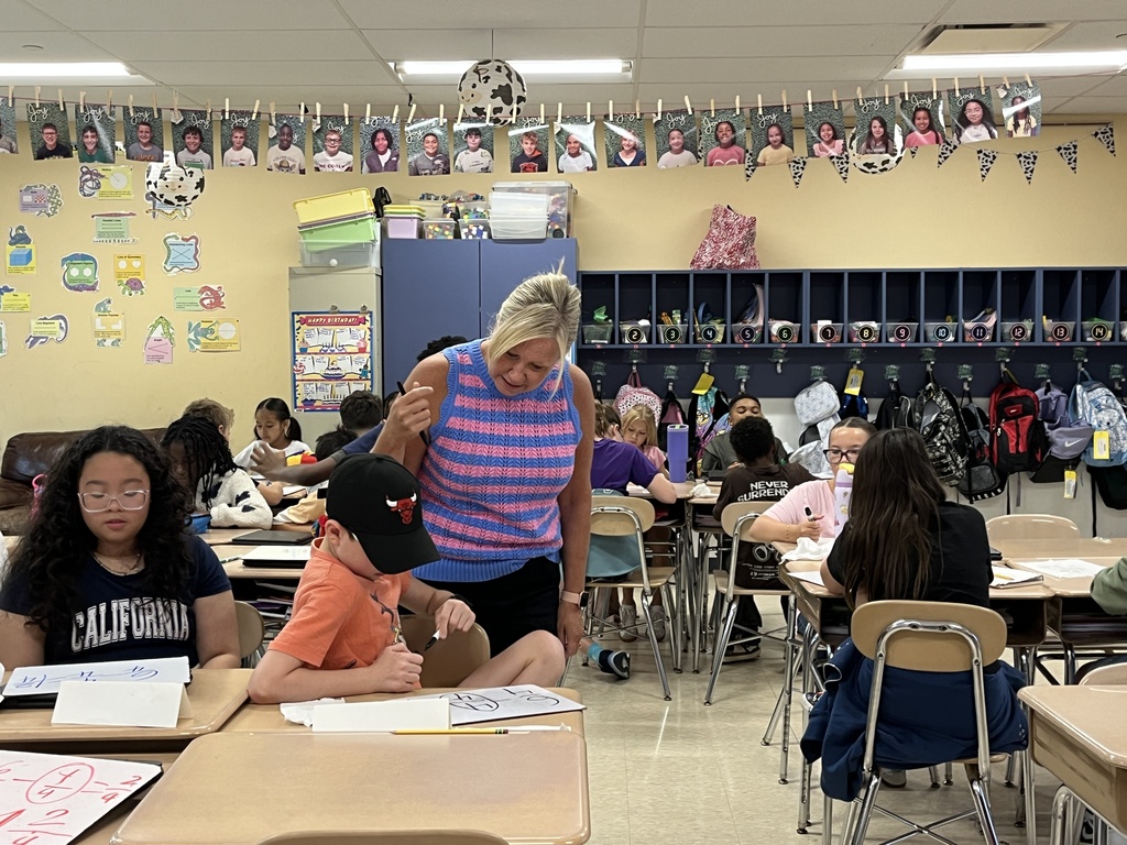 Converting improper fractions to mixed numbers during Math in Ms. McCowen's class! 
