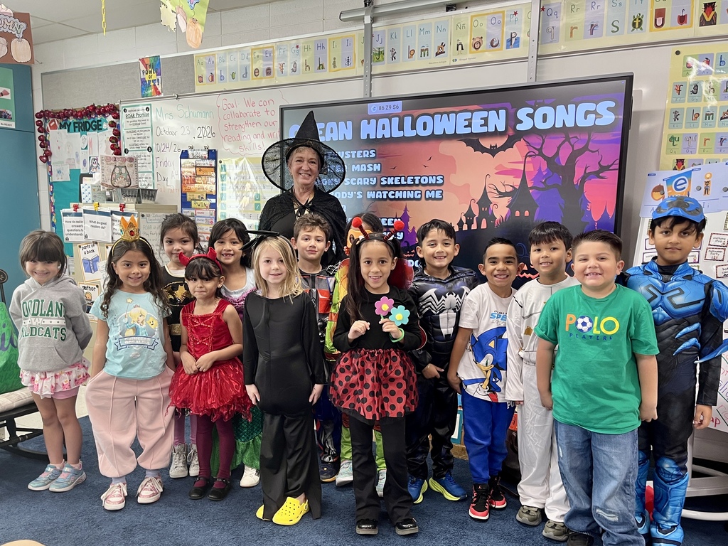 Group class photo of teacher and students wearing costumes