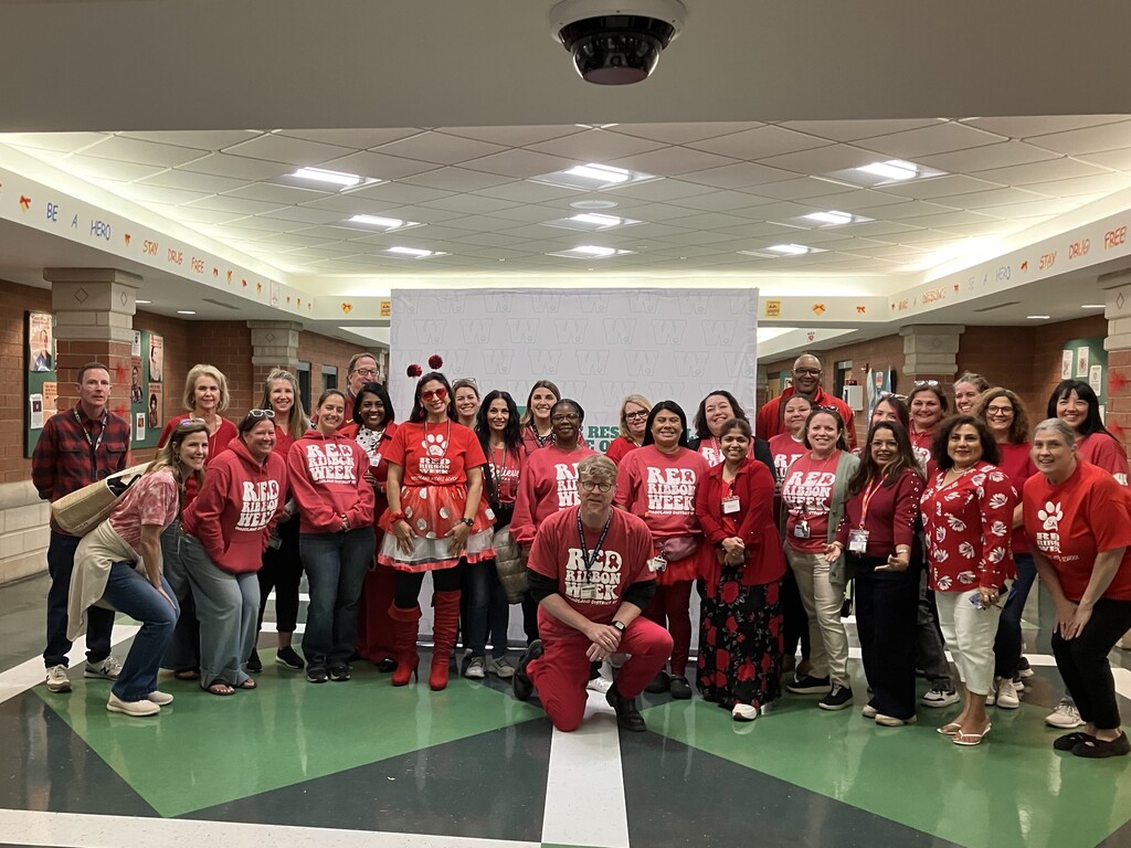 large group photo of Middle School staff wearing Red Ribbon Week shirts/sweatshirts