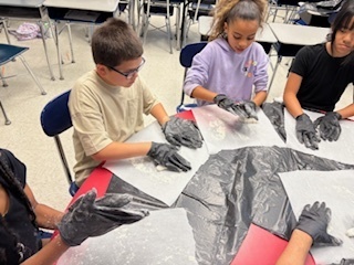 students rolling pretzel dough