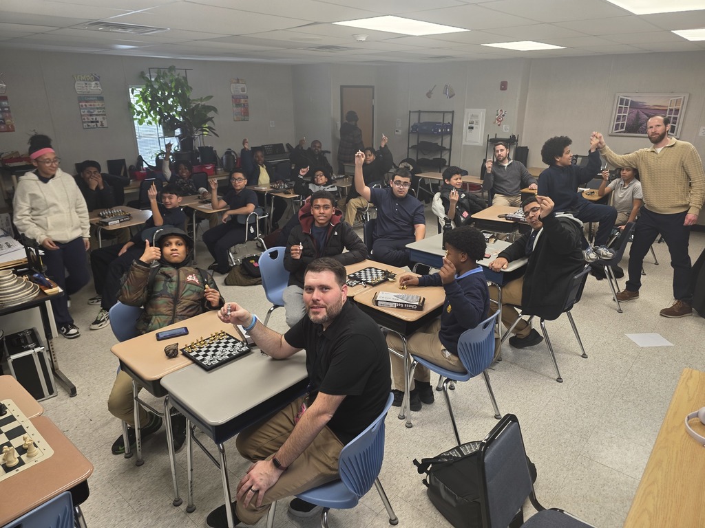 students playing chess against teachers