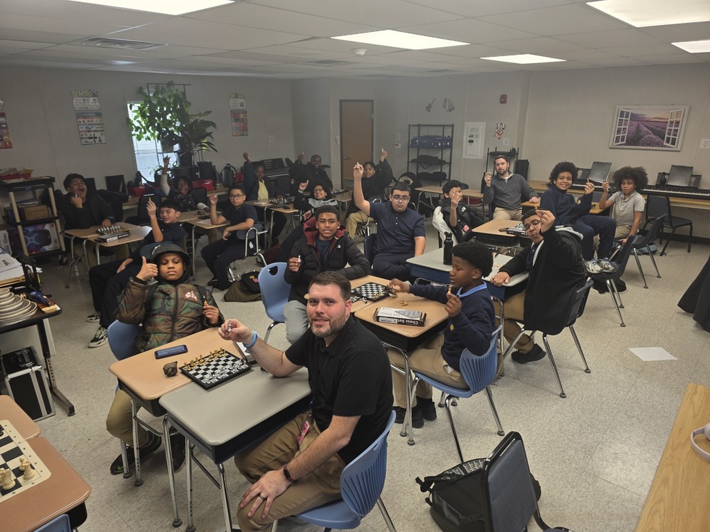 students playing chess against teachers