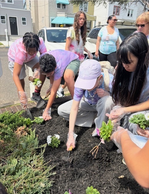 Students planting flowers in the garden
