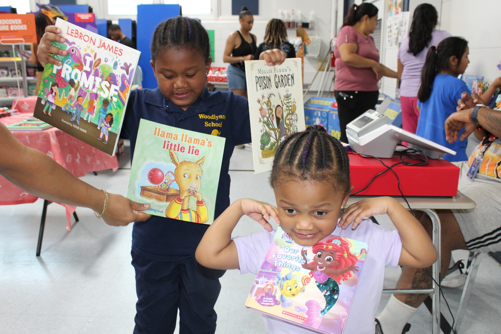 students showing their books they got at the book fair