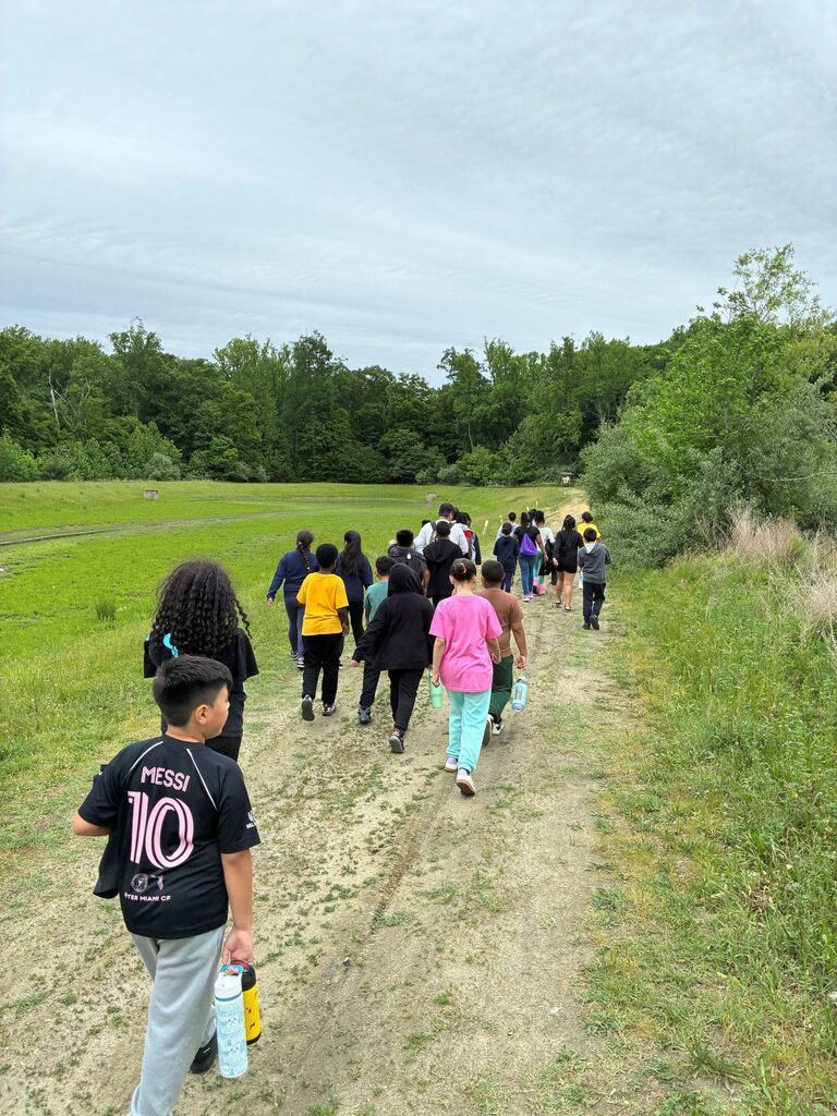 students hiking to a dig