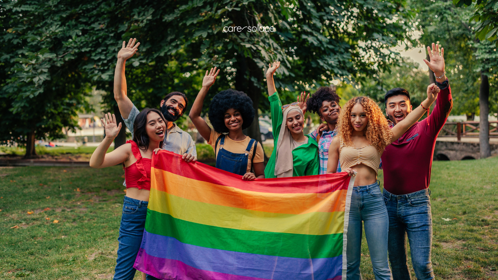 natioanl pride month with rainbo flag and students holding their hand up