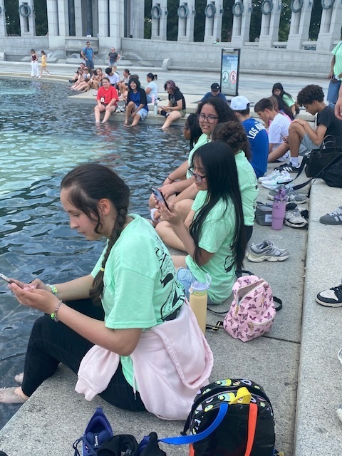 students sitting on cement park step