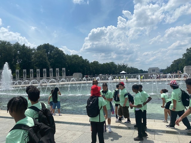 students by the reflecting pool