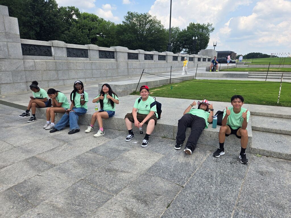 students sitting on cement park step