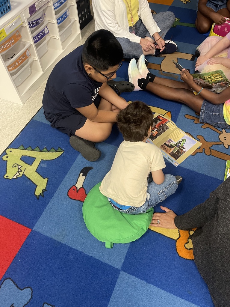 older student reading to younger student