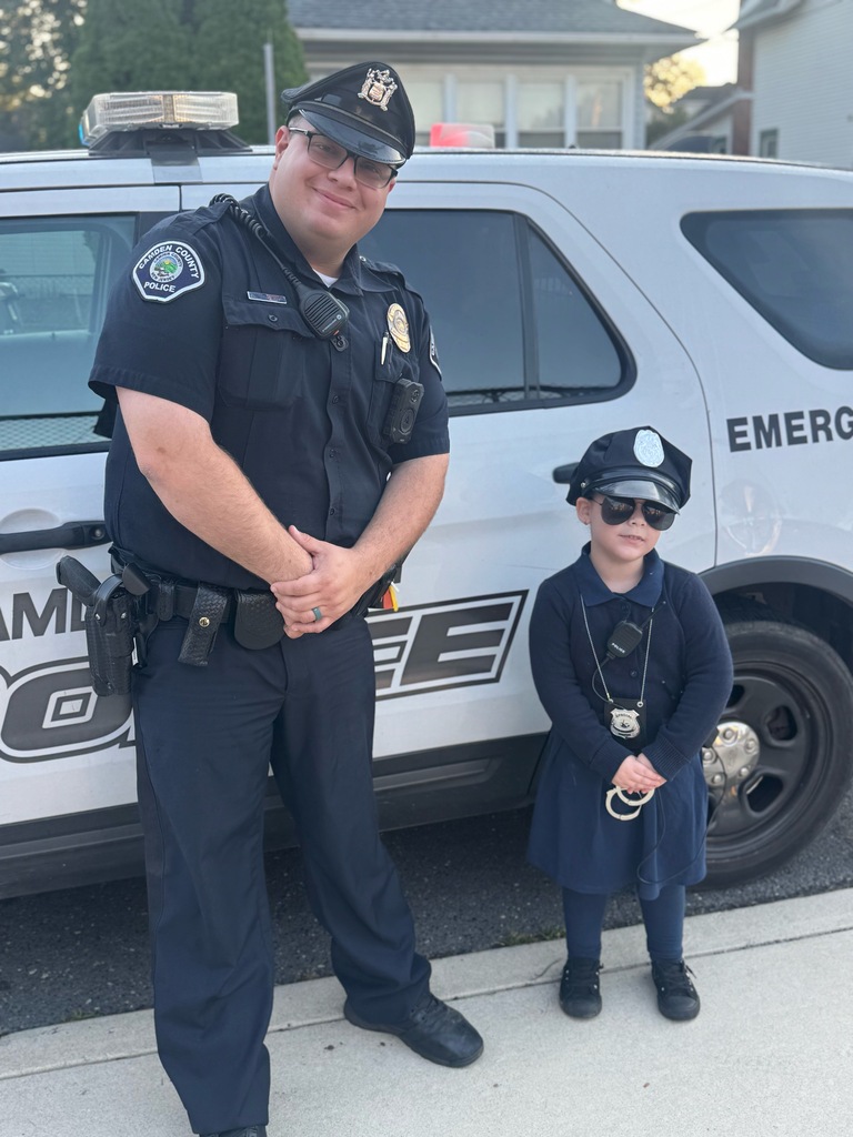 student dressed as a police officer, next to a police officer