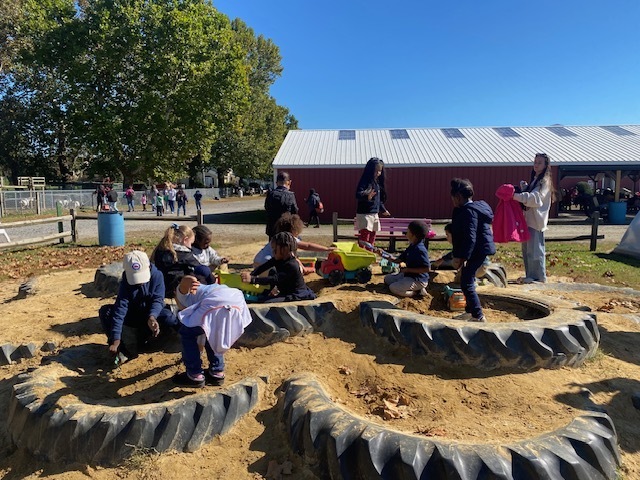 students playing in a dirt playground