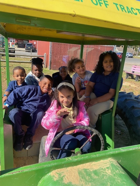 students on a fake tractor