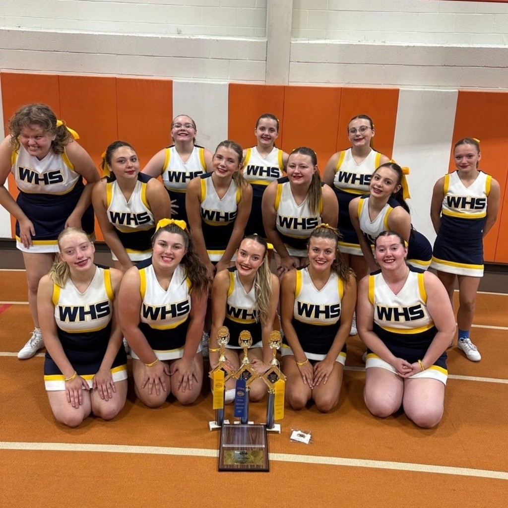 Wildcat Cheerleaders posing with their trophies from UCA cheer camp!