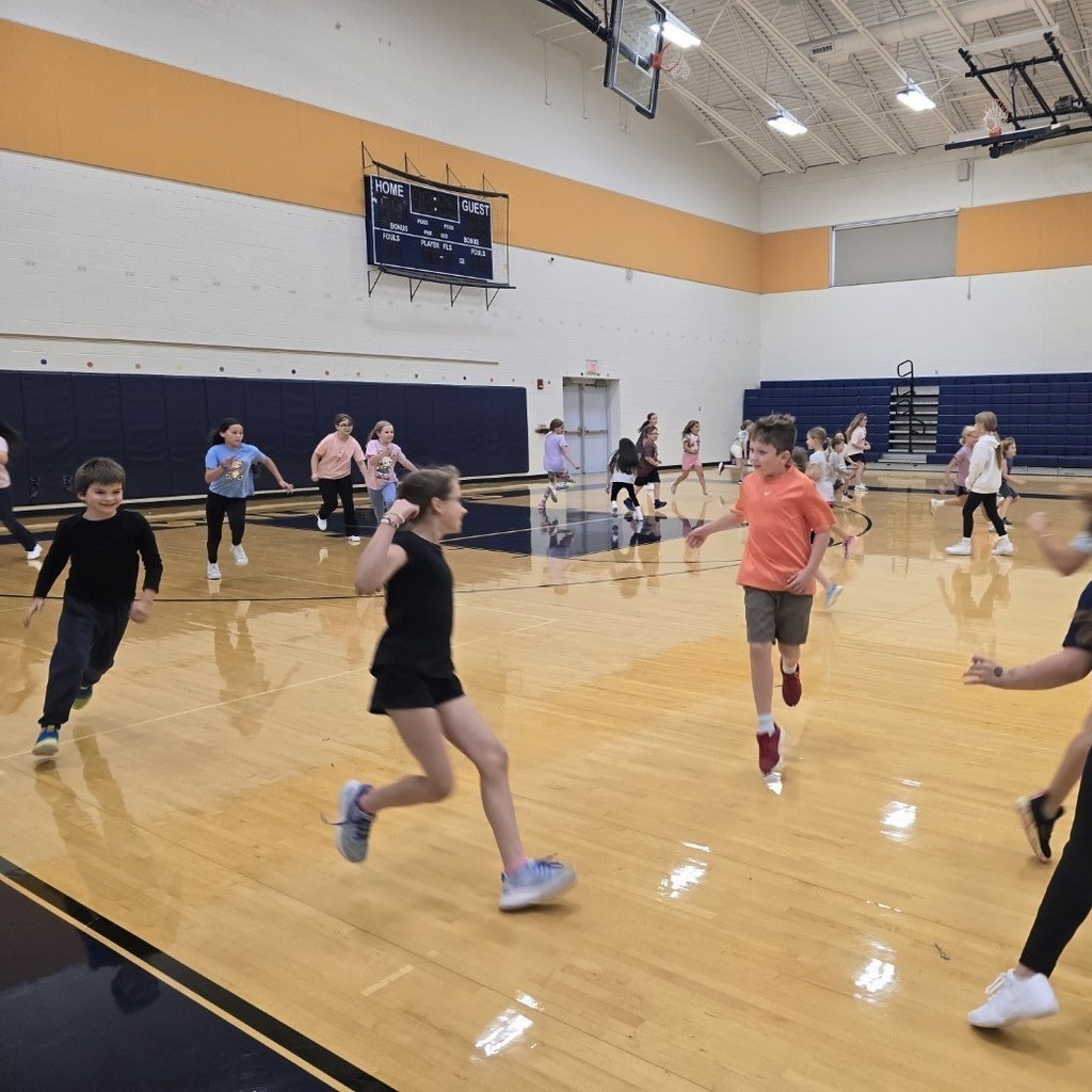 Cheerleaders and second graders play sharks and minnows together!