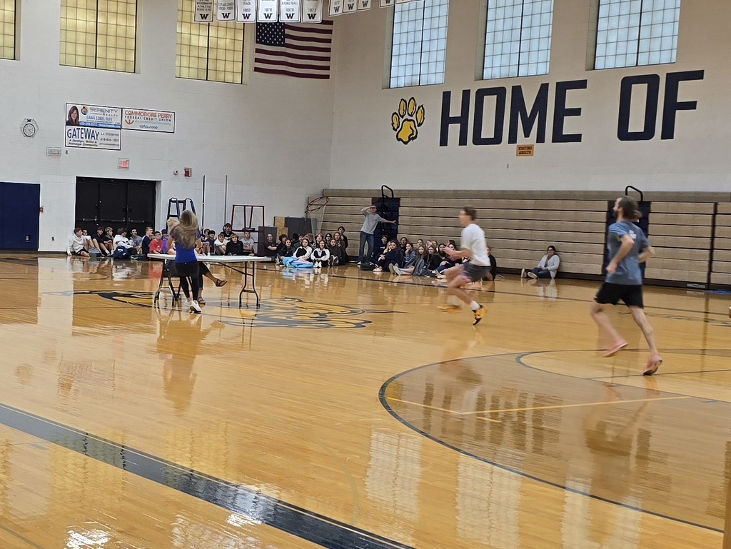 Students (and Mr. Rellstab!) running items out to Mrs. Valasek in the center of the gym for the Scavenger Hunt!