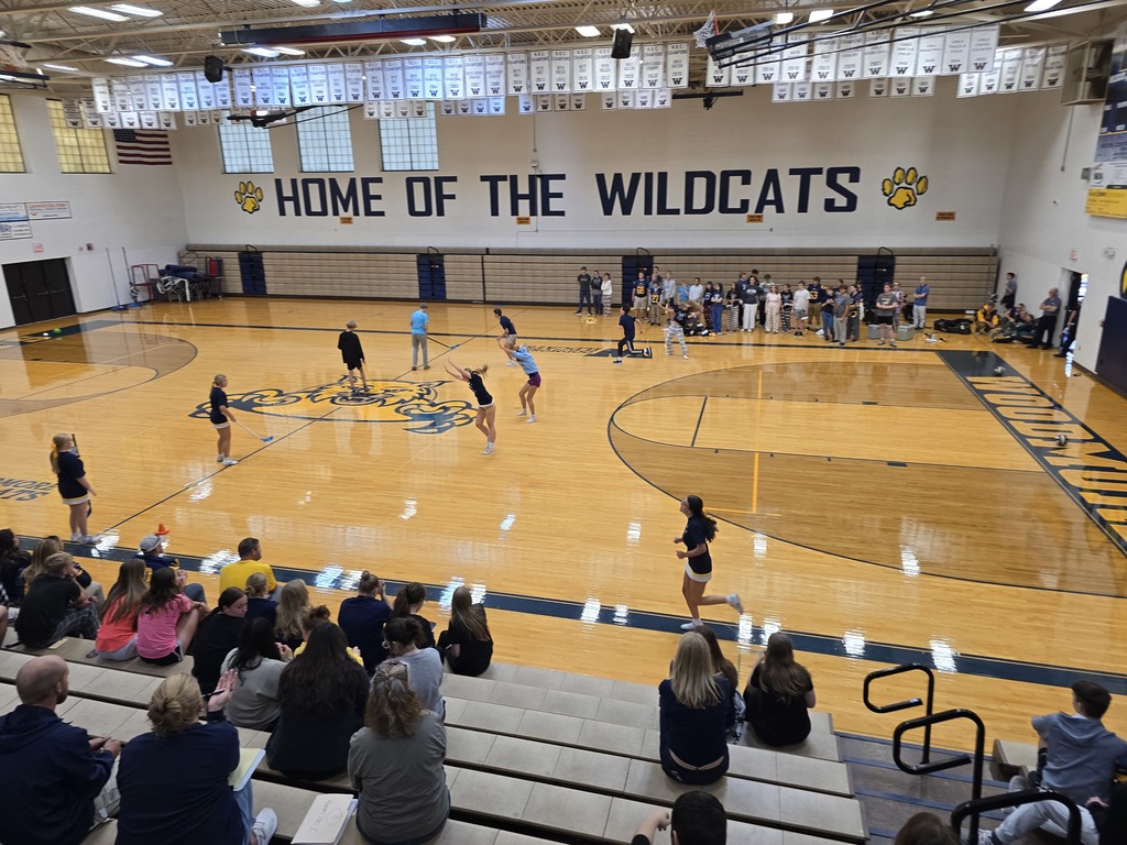 Fall student athletes competing in a relay, currently turning cartwheels down the length of the gym floor. Congratulations boys golf on the win!