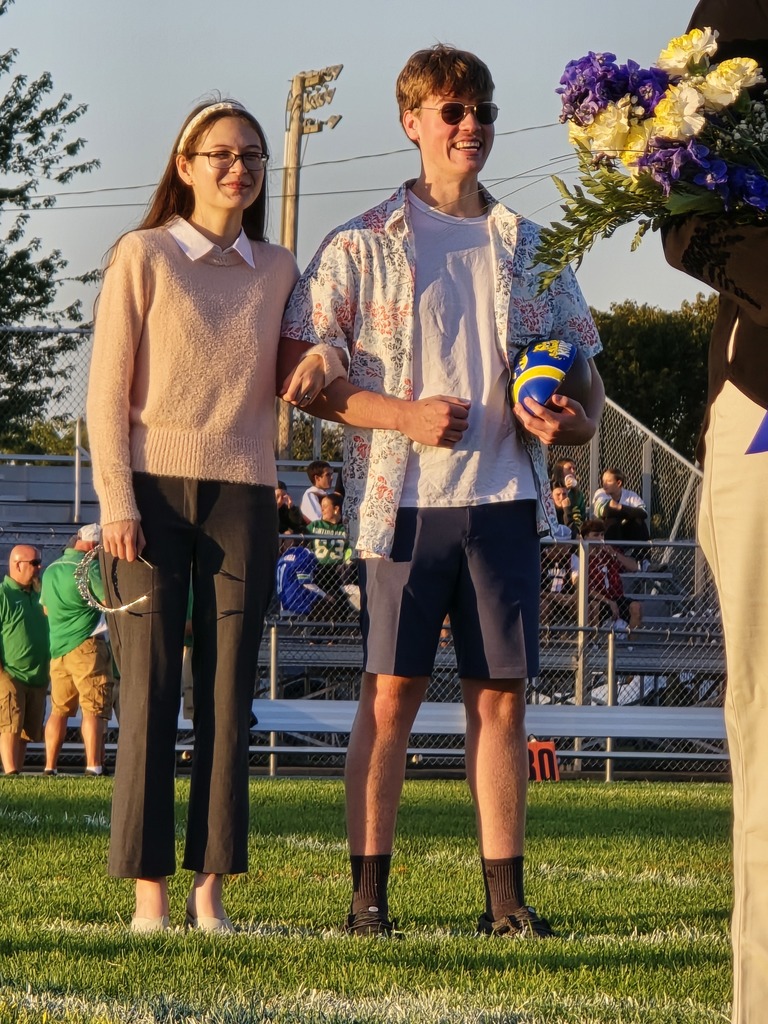 2024 Homecoming King and Queen, back to crown the new King and Queen, pose for a picture on the football field