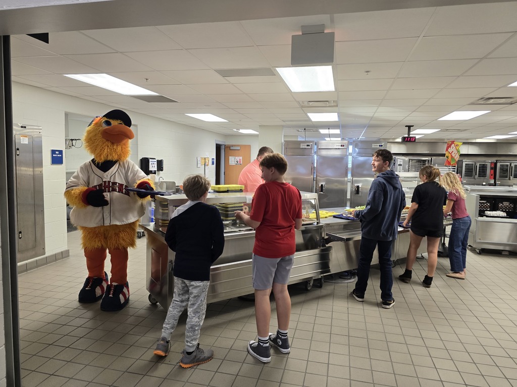 Muddy handing out trays to students in  line to get their lunch.