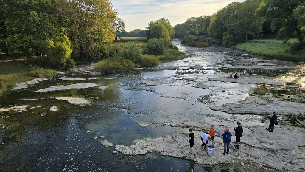 Students standing in the Portage River doing data collection