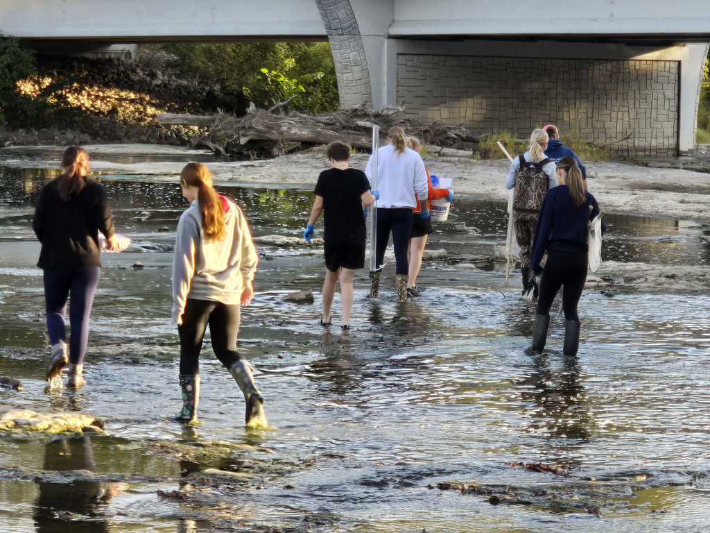Students walking through the Portage to do data collection. They are carrying various instruments that they will use in the process.
