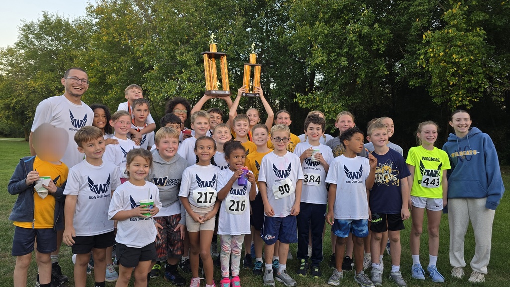 The whole biddy team after the awards were announced, all smiles, holding their trophies in the background!
