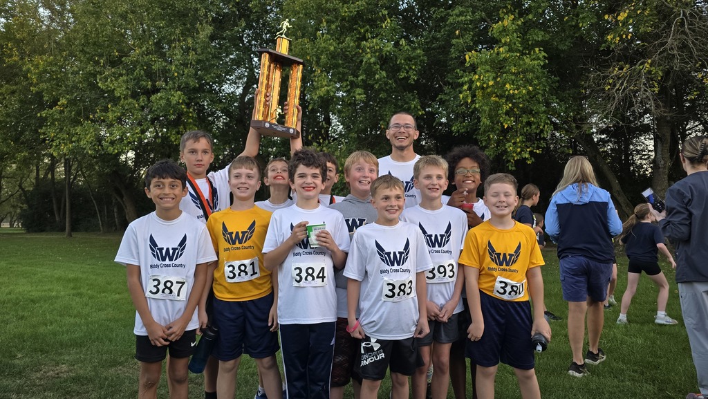The CHAMPION boys 4th-6th team holding their trophy with Mr. Kigar