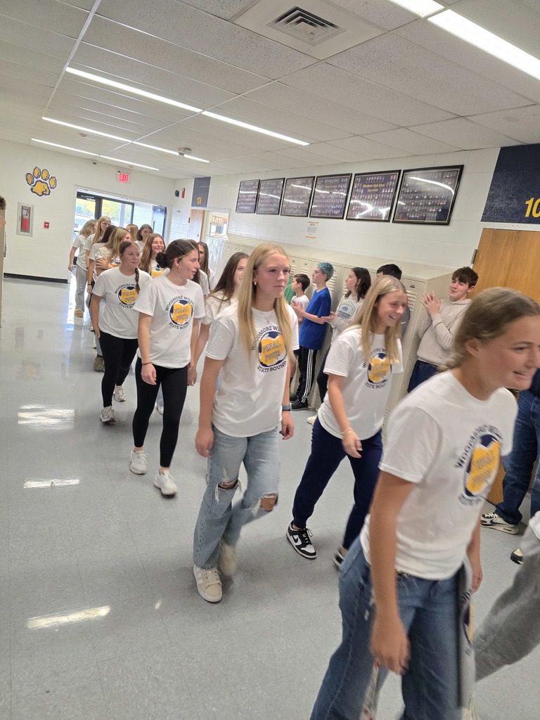 Members of the soccer team walk through the halls of the high school
