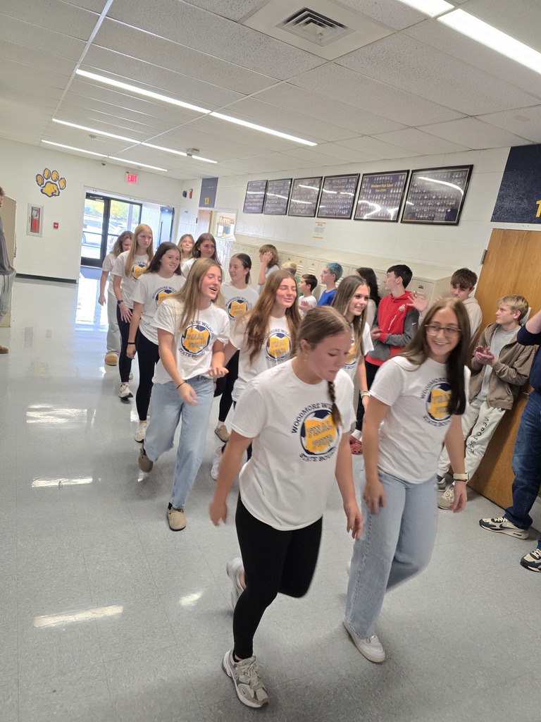 Members of the soccer team walk through the halls of the high school