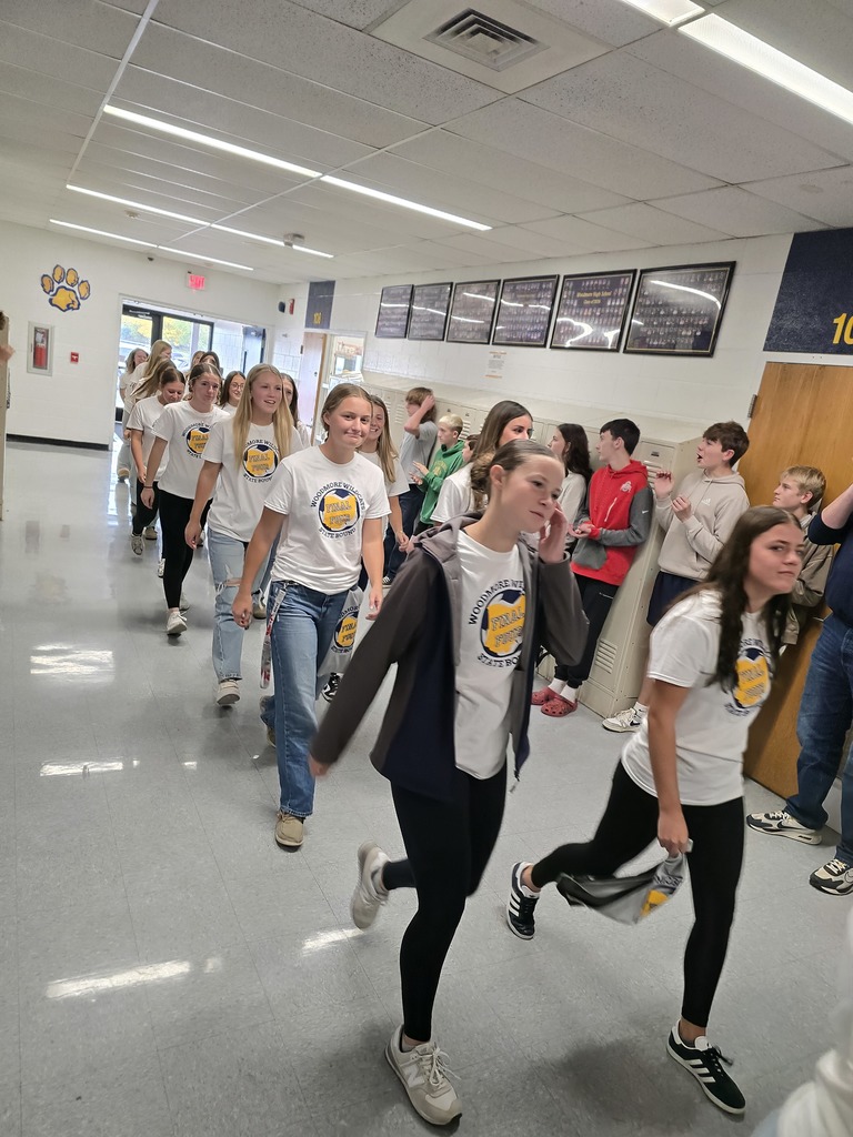 Members of the soccer team walk through the halls of the high school