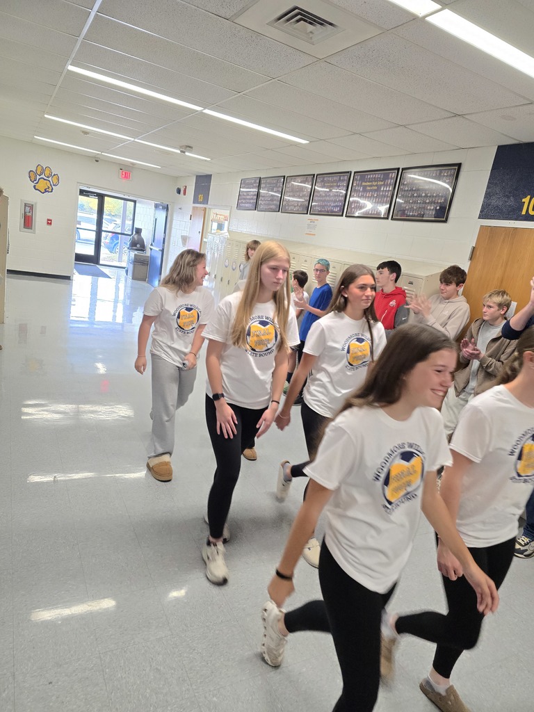 Members of the soccer team walk through the halls of the high school