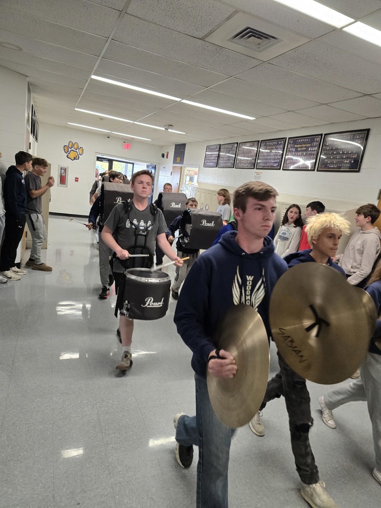 The band leads the procession through the hallways of the high school