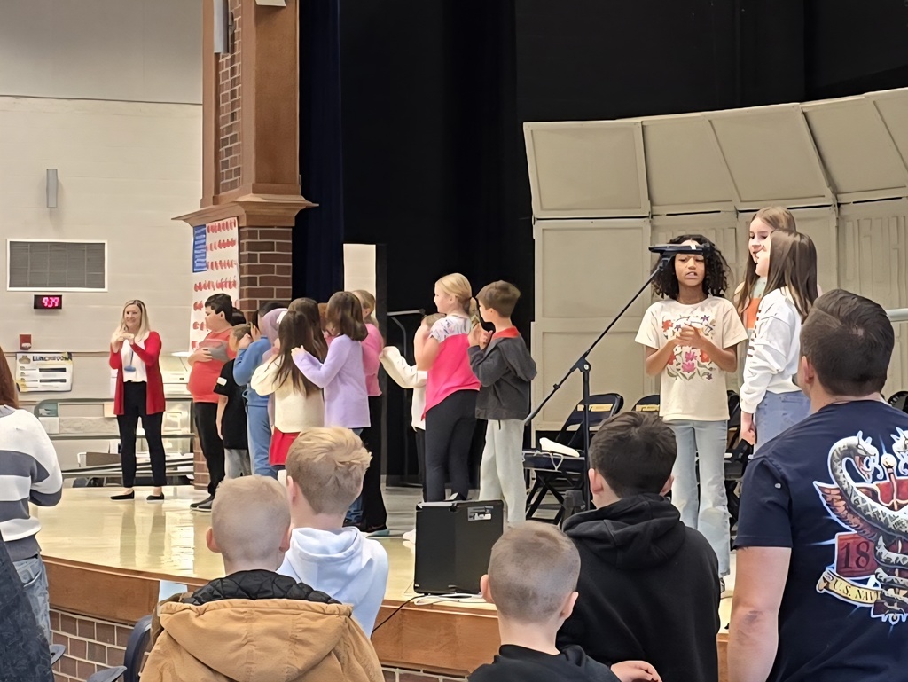 Fourth grade students recite the Pledge of Allegiance while Mrs. Alexander's class signs the Pledge in Americal Sign Language