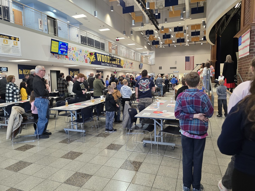 Students and Veterans stand for the Pledge and the National Anthem