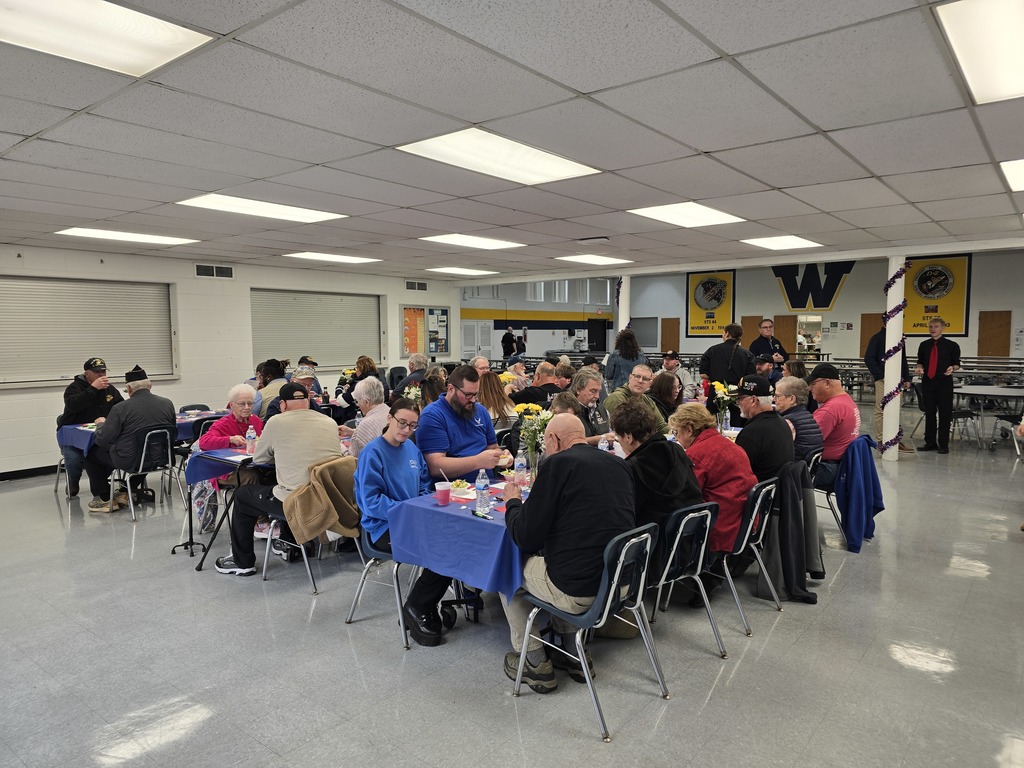 Veterans and their families enjoy a lunch served by students before the Veterans Day program.
