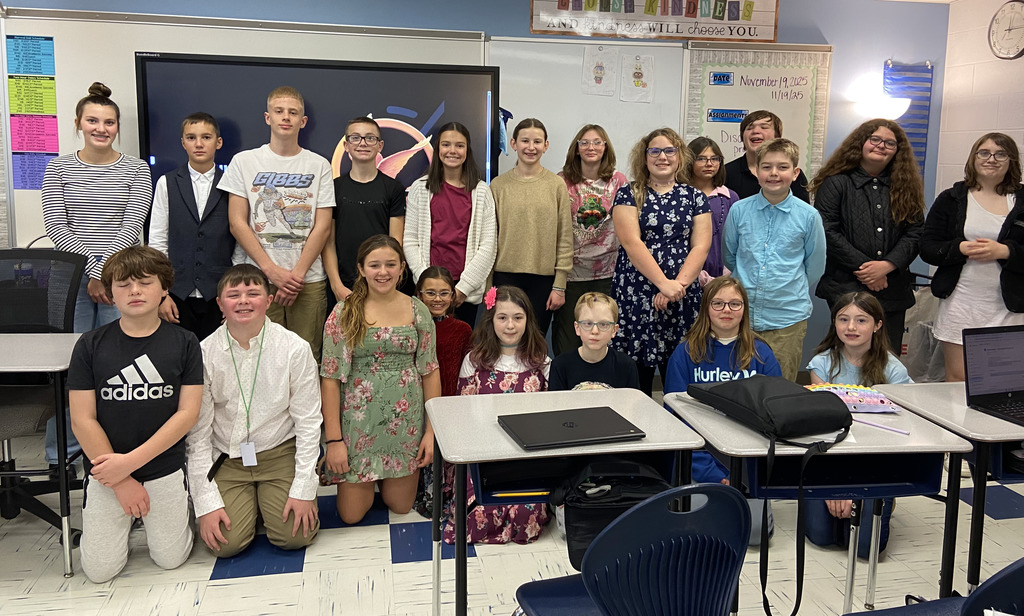 Sixth grade students pose for a picture in their best clothes for their activity.