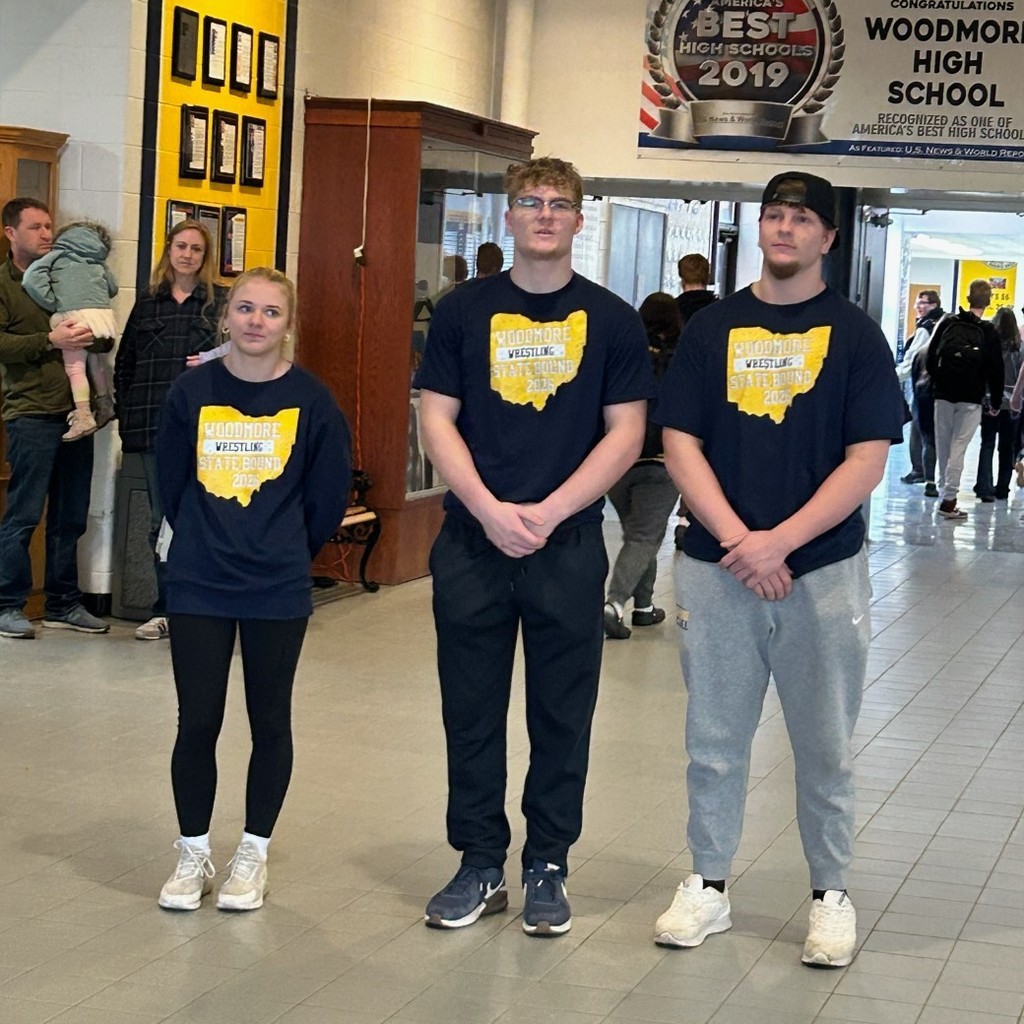 Three state qualifying wrestlers stand in the mail hall for their picture.