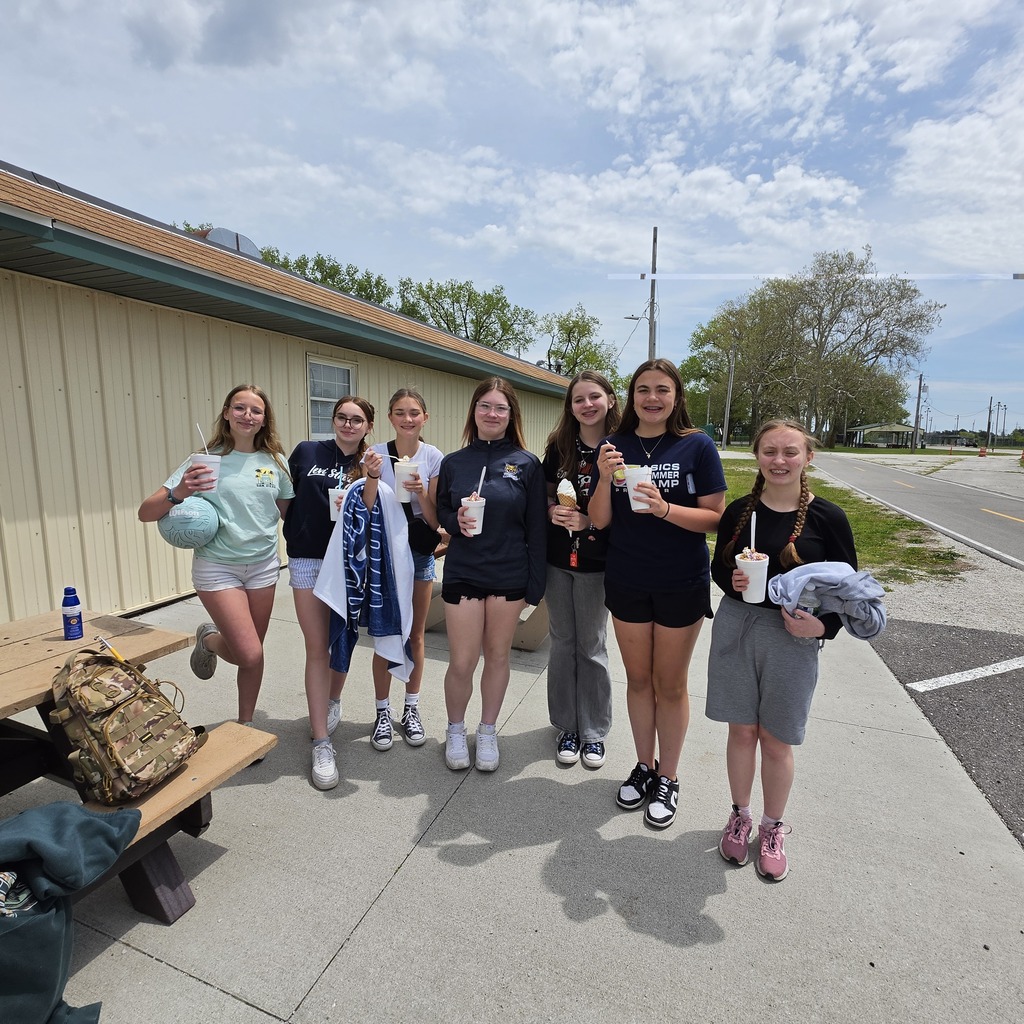 A group of students poses with their ice cream on the concrete next to the Big Dipper in Genoa.