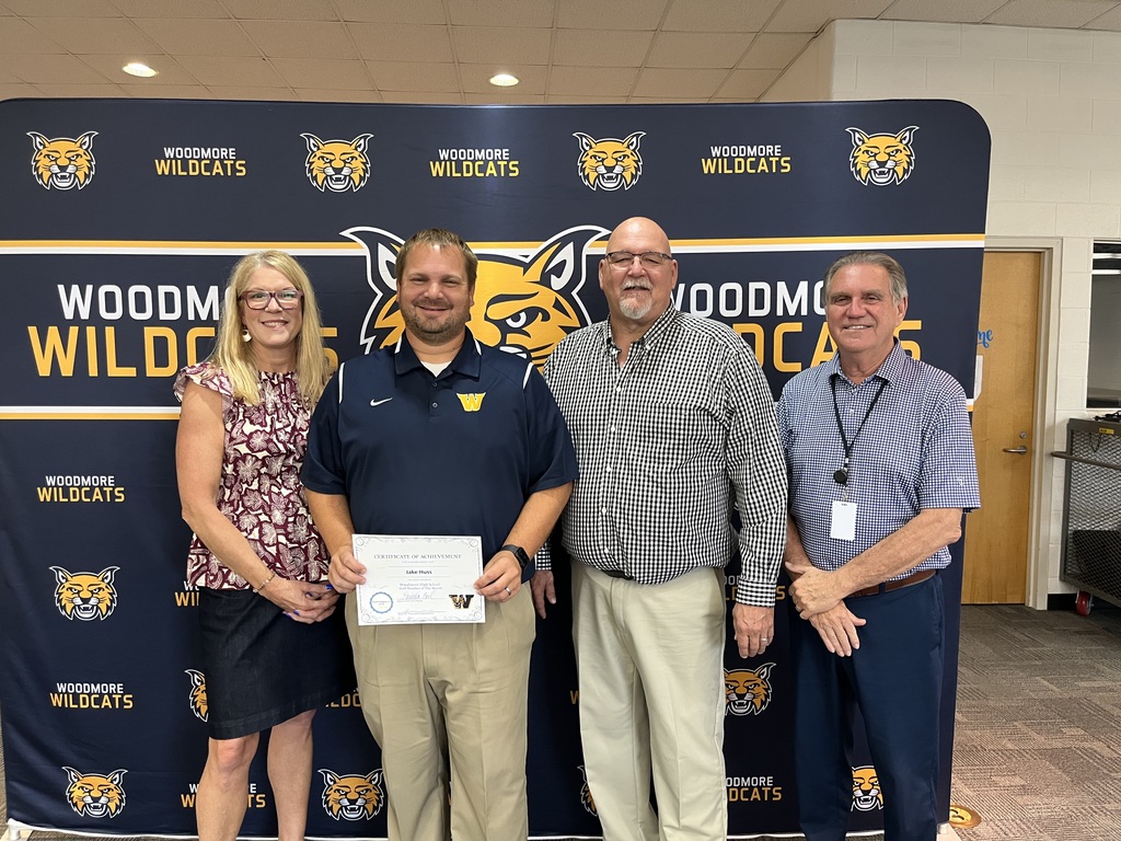 September High School Staff Member of the Month, Jake Huss, pictured with high school principal Loretta Coil, Board President Jan Busdeker, and Superintendent Denny Mock.