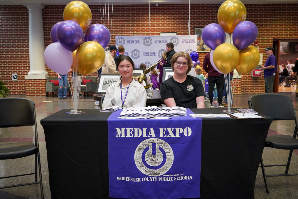 students sitting at welcome table