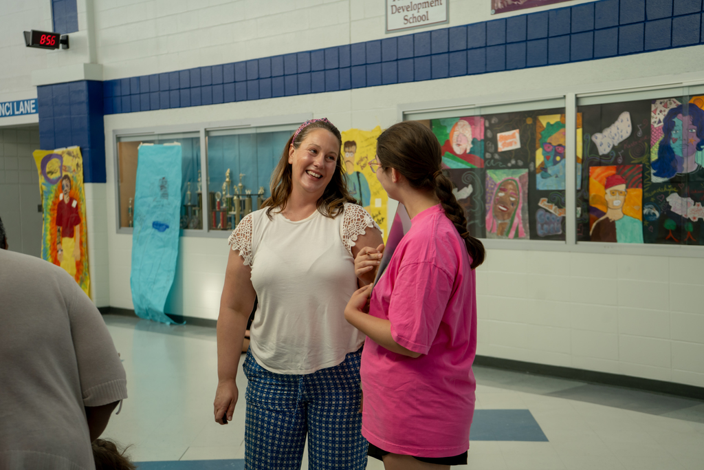 Teacher smiling at student