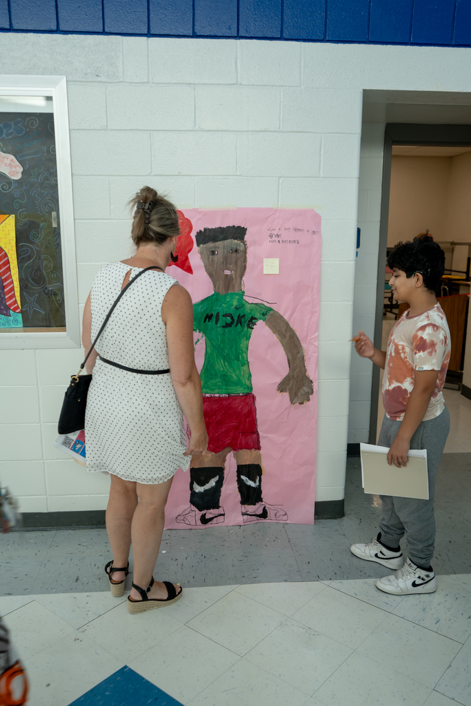 Teacher and student looking at artwork