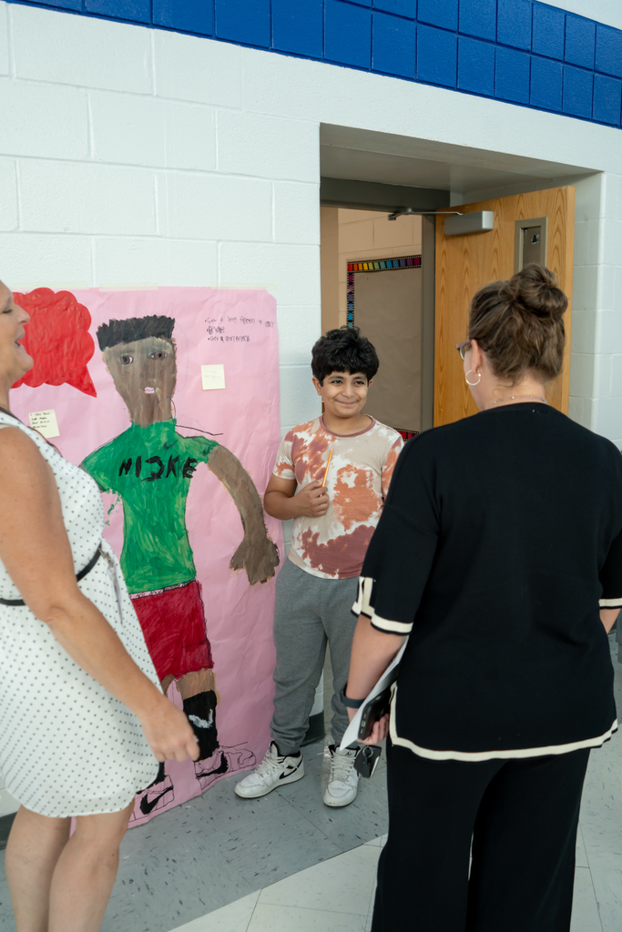 Teacher and student looking at artwork